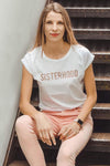 SISTERHOOD tee in white styled with pink jeans by Mama Life London